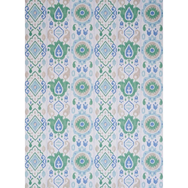 This delicate, muted striped wallcovering captures the look of a warp print ikat with watery colorations and an exotic...