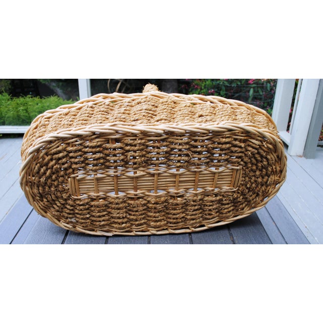 This is a very large woven basket that will inspire many uses. It is sisal style rope held together with twisted wood...