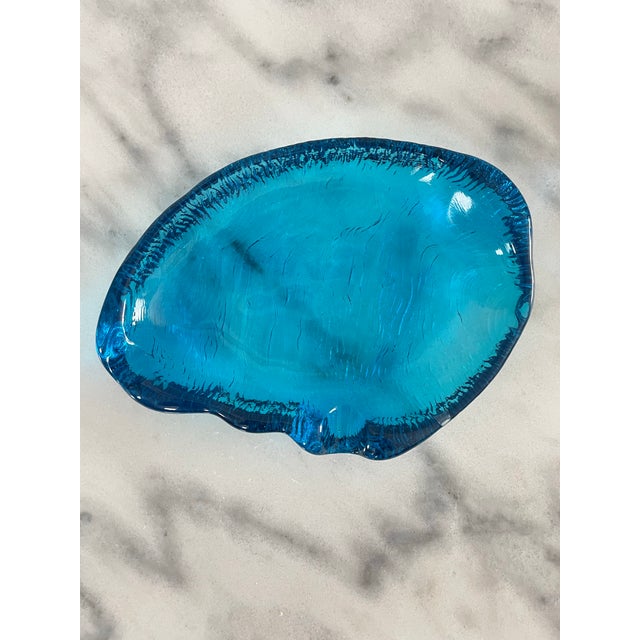 A great vintage ashtray with vivid sapphire blue coloring and textured impression glass on the bottom. The amorphous dish...