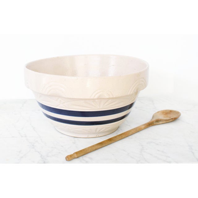 This antique bowl is very large. It's one of the utilitarian blue stripe large mixing bowl's by Roseville Pottery, and is...