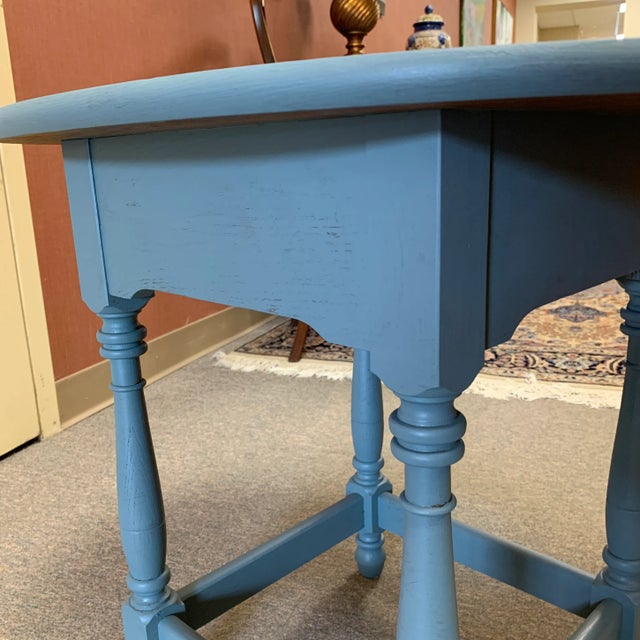 Dated from the 1970s. Traditional, country, and rustic styles. Oval shaped side table. Painted teal. A great addition to...