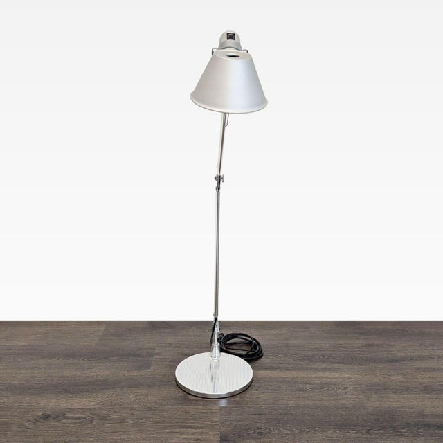 This Artemide floor lamp features a sleek chrome finish and adjustable arm, perfect for focused task lighting. The sturdy...