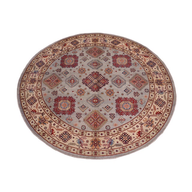 Enhance your home with this exquisite hand-knotted Kazak rug, crafted from fine hand-spun wool and dyed with all-natural...