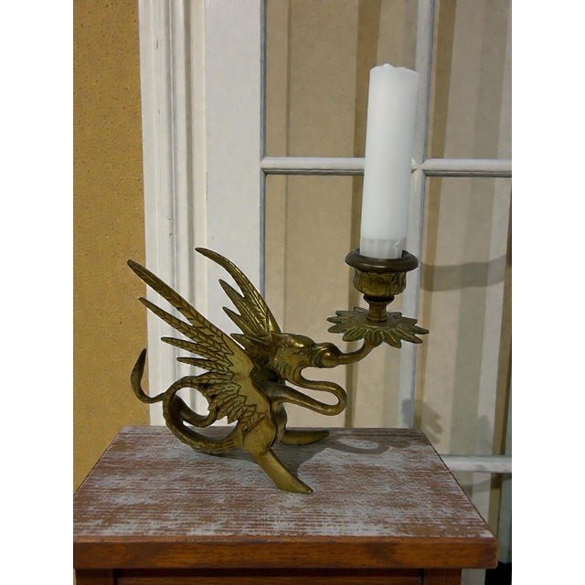 A wonderfully atmospheric vintage cast brass figural candlestick formed as a winged griffin (dragon/wyvern) holding a...