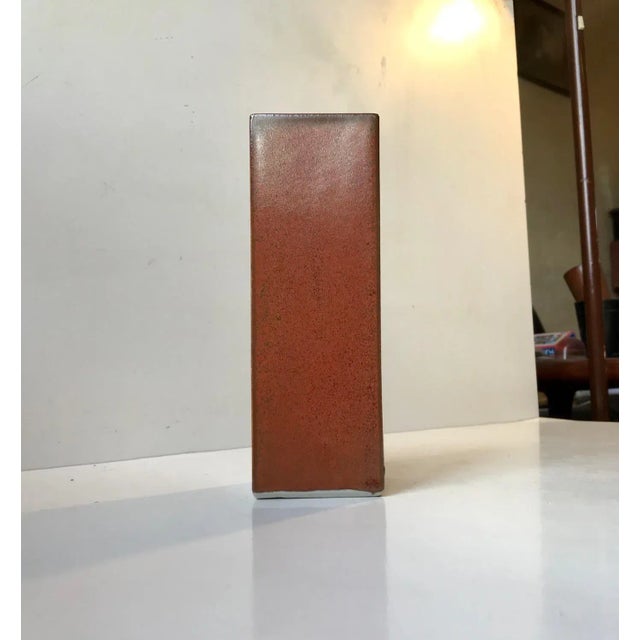 A rectangular Japanese Ikebana vase in orange with speckles in earthy brown/green glazes. Ikebana is the Japanese...