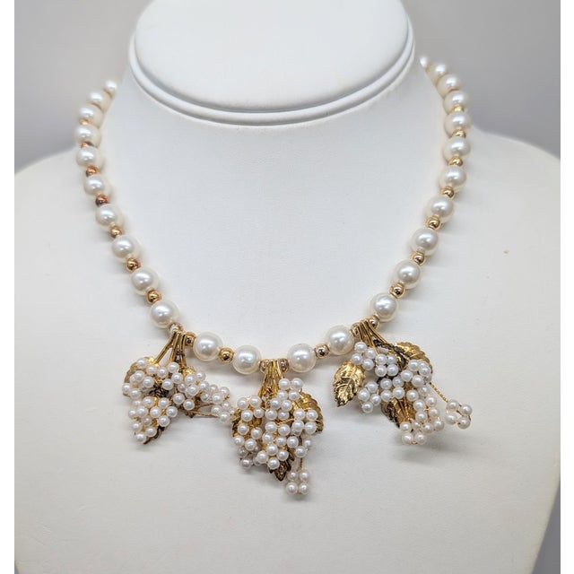1980s goldtone faux-pearls with three faux-pearl grape clusters with goldtone leaves necklace with box clasp with the...