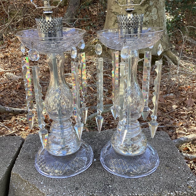 Impressive pair of large clear crystal table lamps, showcasing elegant turned forms and classic pedestal bases with...