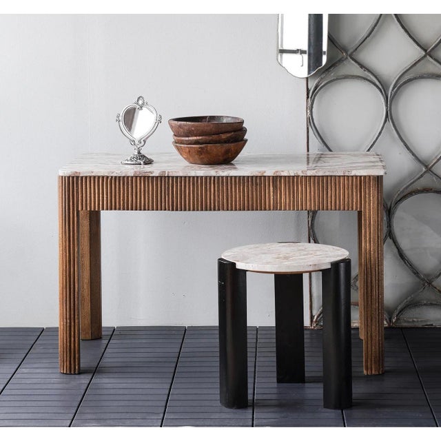 Table is shaped from mango wood slats atop a solid frame. The wood is finished with plastic paint, providing a deep...