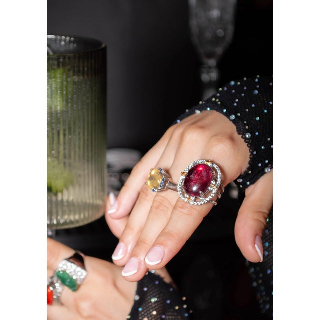 Stunning cocktail ring featuring a rich purplish-red 20.5-carat rubellite tourmaline cabochon from Brazil. We sourced the...