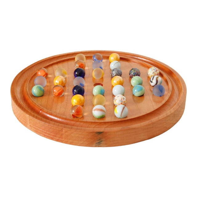 A solitaire game with a handmade round wooden playing tray and 32 colored marbles. The tray has beautiful grain and a deep...