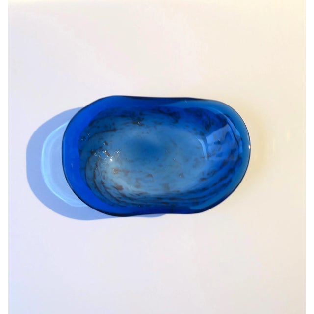 A blue and white art glass bowl with copper colored shimmer in the Italian Murano style, oval in shape, circa late-20th...