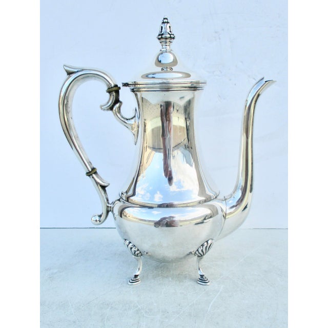 Sterling Silver Coffe pot on four legs, with a raised ball belly. Maker Mueck Cary Co. New York circa 1950s'. Pear-shaped...