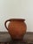 An antique French terracotta jug from the 19th century, wheel-thrown in red earthenware with an applied loop handle. The...