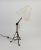 Brass tilting lamp whose tripod and stem base are equipped with hooks to position it in wall light. Verse 1910-1920...