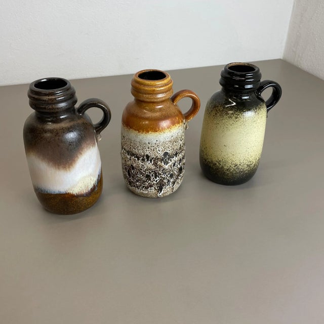 Set of three fat lava art vases Model: 413-20 Producer: Scheurich, Germany Decade: 1970s These original vintage vases was...