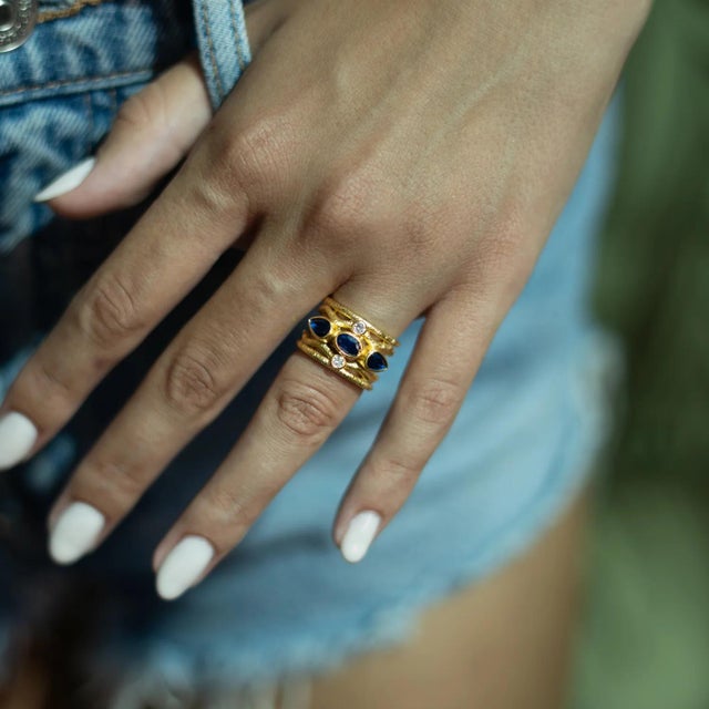 The Sapphire & Diamond Regal Adjustable Gold Ring captures a sense of royal elegance and spiritual depth. Showcasing three...