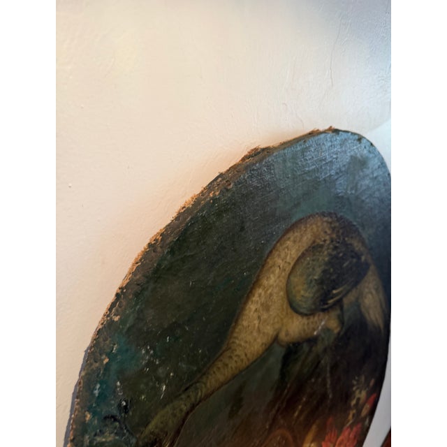 striking 19th-century European oil painting depicting a peacock in a lush landscape, reaching for a cluster of grapes...