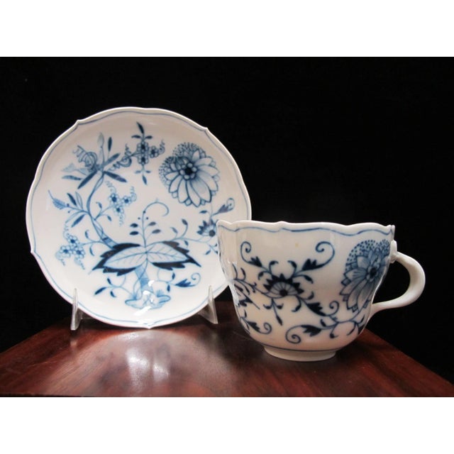 Meissen porcelain coffee cup and saucer set in classic Blue Onion (Zweibelmuster) pattern. Scalloped rim on cup and...