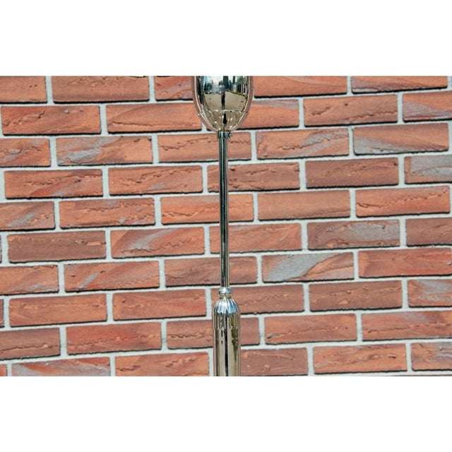 A beautiful chandelier with a very modern design. The lamp's metal frame features five curved arms that extend...