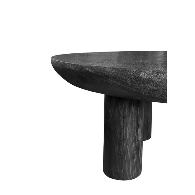 This striking coffee table is crafted from solid suar wood and finished in a deep burnt black tone that highlights the...
