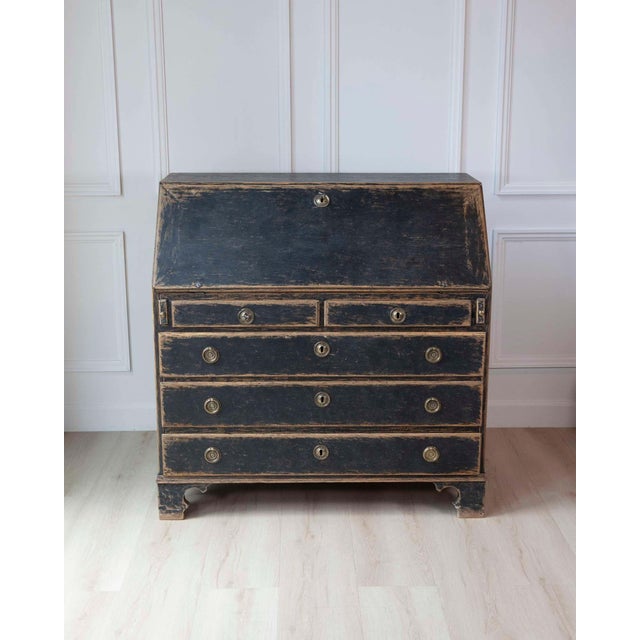 A beautifully proportioned Swedish Gustavian period slant front desk, retaining a wonderfully aged black-painted exterior...