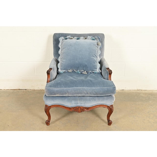 An outstanding French Louis XV style carved walnut bergère chair or lounge chair with ottoman In the manner of Baker...
