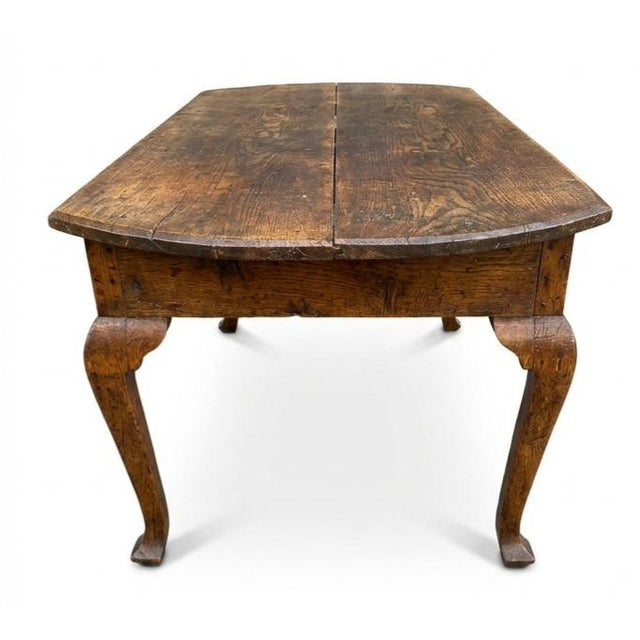 French Provincial Louis XV Farmhouse Table. It features a rustic plank top with breadboard ends, a simple unadorned apron,...