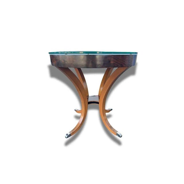 Pair of Regency round side tables with glass tops. Wood with brass feet. These side tables are of high quality and are...