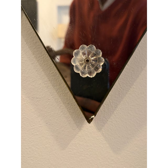 Opulent diamond-shaped Art Deco mirror from 1930s fashioned with typical glass rosette mounts, geometric ornamentation and...