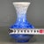 A striking Chinese porcelain vase featuring a vibrant blue crystalline glaze. The vase has a classic pear shape with a...