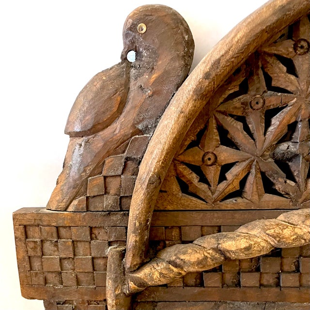 This intricately hand-carved wooden wall mirror makes an exotic "boho" statement. Features a moorish arch topped with two...