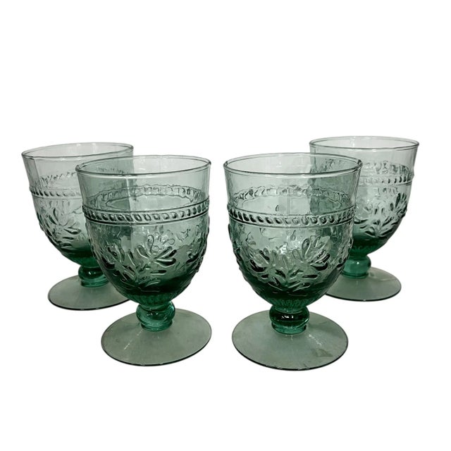Vintage set of four pale green pressed glass wine goblets. In display only condition with original labels still attached....