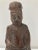 Very old solid wood statue depicts a Chinese ancestor figure. He wears typical Tao robe and hat. On the back of statue,...