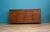 A large 1970s sideboard with carved dragon panels across the four cupboard doors and matching detail to the top drawers....