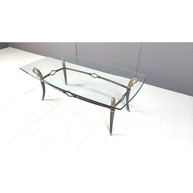 Mid century hollywood regency style coffee table made from brass and grey metal with a beautiful clear glass top. Elegant...