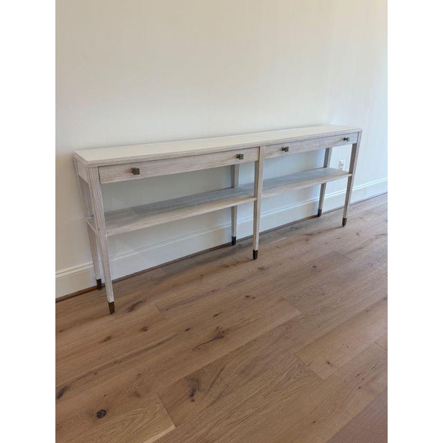 Theodore Alexander Breeze Console with Stone Top Slim frame of cerused pine in Sea Salt finish with a forgiving limestone...