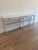 Theodore Alexander Breeze Console with Stone Top Slim frame of cerused pine in Sea Salt finish with a forgiving limestone...
