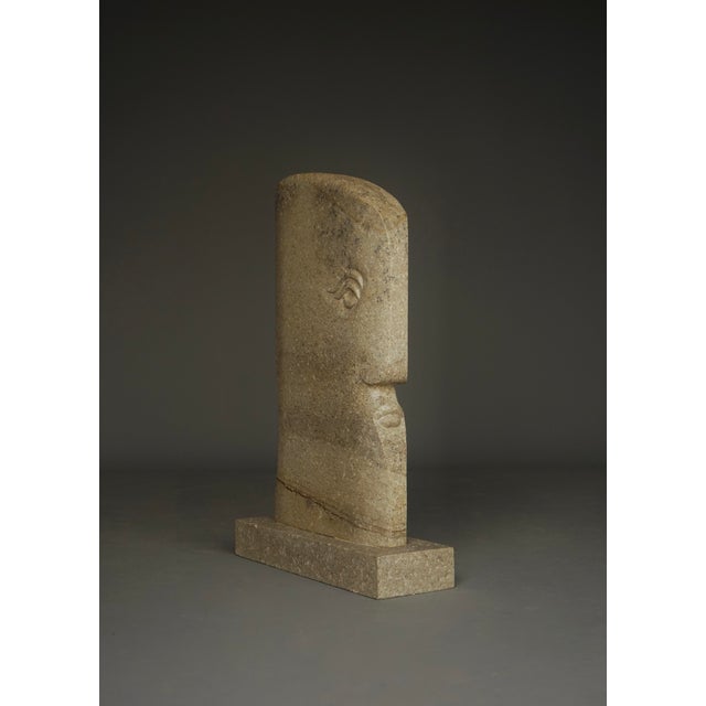 An impressive and beautifully designed sculpture of a male head. Its elongated vertical form shares stylistic qualities...
