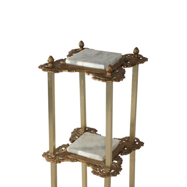 Presenting an antique Victorian plant stand offering bronzed metal frame with reeded legs, foliate platform frames housing...