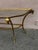 Vintage Console table styled after Maison Jansen with a brass base. The console table is topped with glass and has ram...