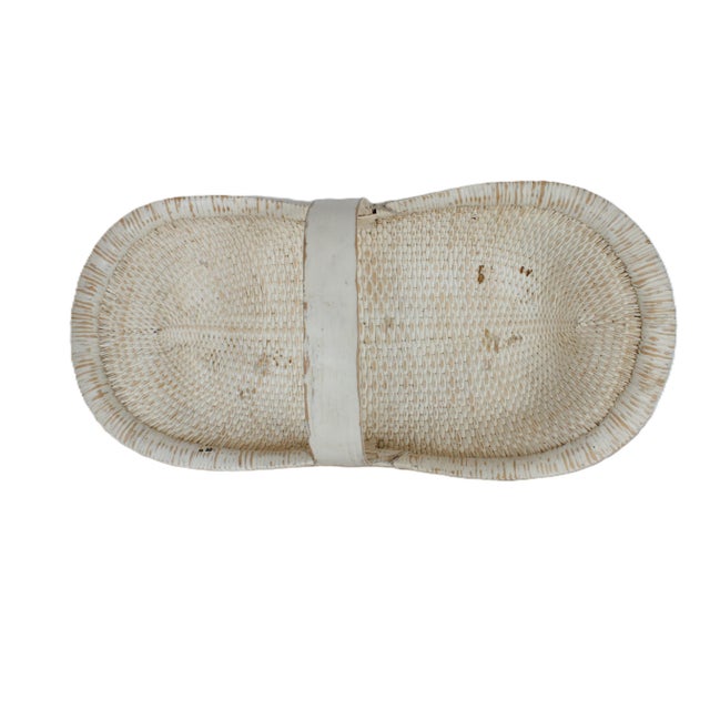 Large rustic weathered white weathered white harvest basket, made of woven rattan and bamboo.