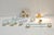 Designer bathroom accessory set in aquamarine glass, gold details, and supports that appear to be made of marble or...