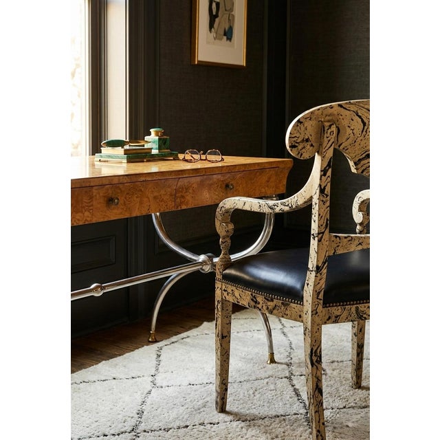 This is a striking 1970s arm chair with a faux marbleized painted finish. It also features a black leather seat with brass...