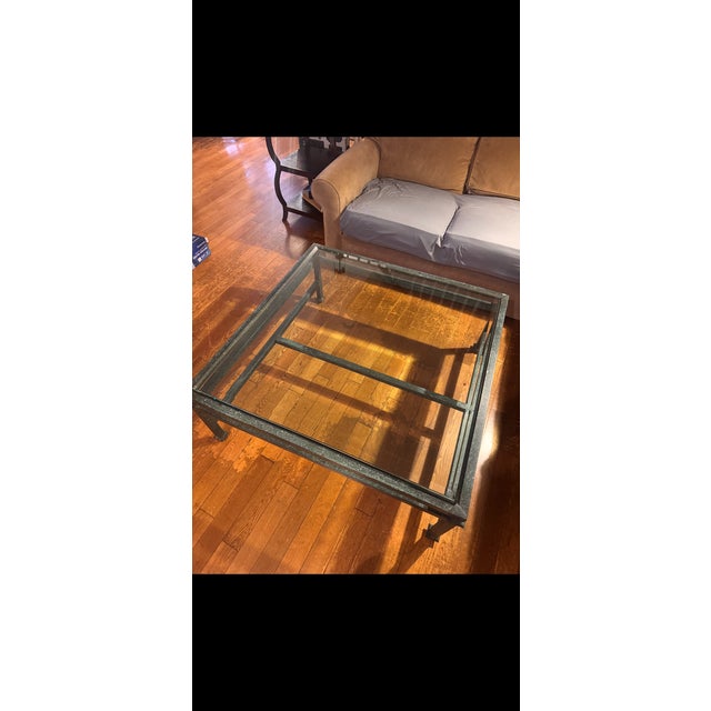 1990’s handsome iron and beveled glass coffee table with green patina. The glass is very substantial. There is no...