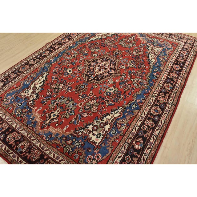 An authentic vintage traditional Hamedan rug hand-knotted with fine wool and natural dyes. This oriental rug features a...