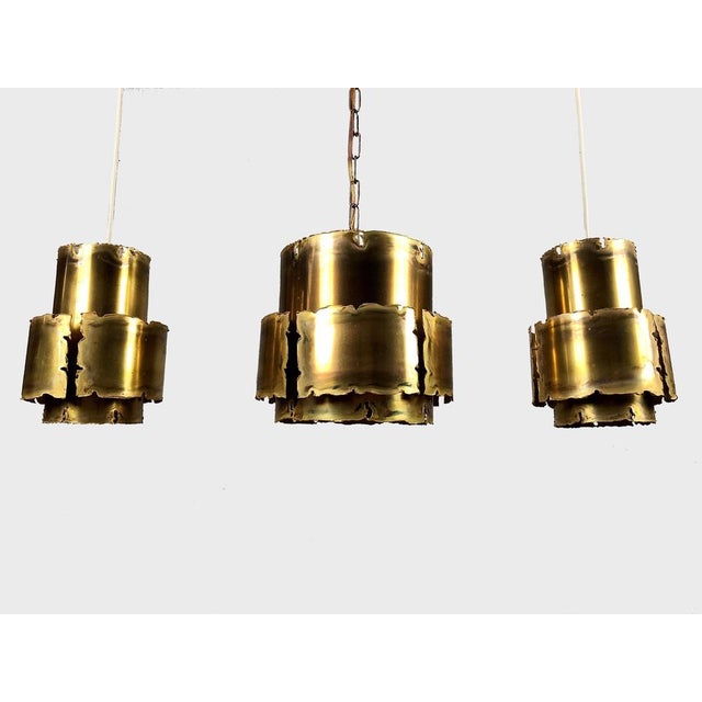 1960´s set of three brutalist style pendants by svend aage holm sorensen the acid treated and torch-cut pendants in brass...