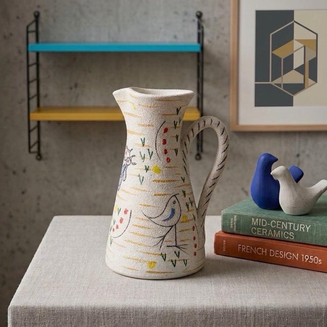 We absolutely love this 1950s pitcher. We adore its joyful modernity, its slightly bucolic whimsy, and above all, the...