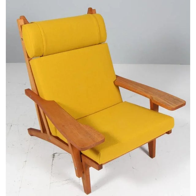 Hans j. Wegner lounge chair with loose cushions new upholstered with yellowhallingdal wool from kvadrat. Frame of oak....