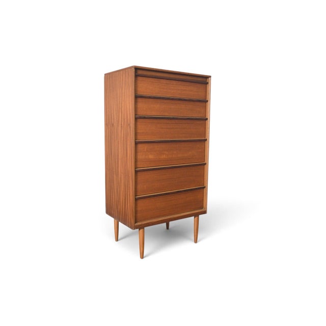 This narrow highboy dresser was made by Austinsuite in England during the 1960s. The case combines teak and rosewood,...