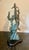 A striking vintage marine life sculpture depicting a breaching Humpback whale and calf navigating coastal ocean currents....